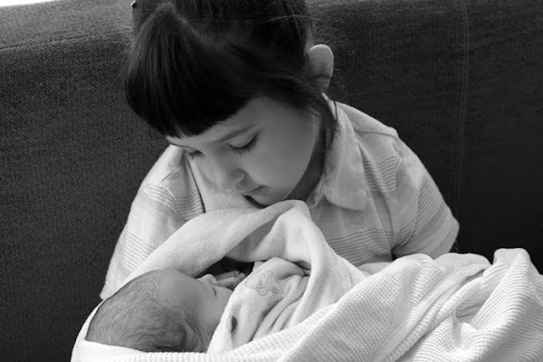 Lily holding her baby sister Lucy