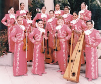 Photo of Mariachi Reyna de Los Angeles dressed in pink mariachi costumes and holding instruments