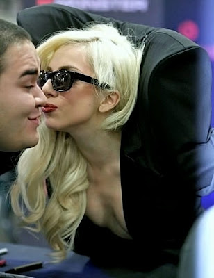 Lady Gaga kisses a fan at the Lady Gaga Kisses. Lady Gaga kisses a fan at the