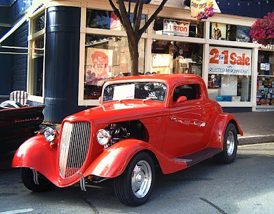 free photo of a bright red vintage coupe done up in as a hot-rod