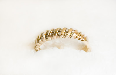 gold eternity band with small diamonds