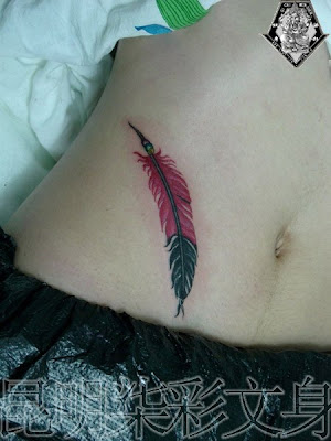 Red feather tattoo on the hip