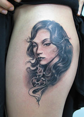 A girl's portrait tattoo on the arm