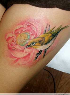 Bird and flower tattoo on the leg