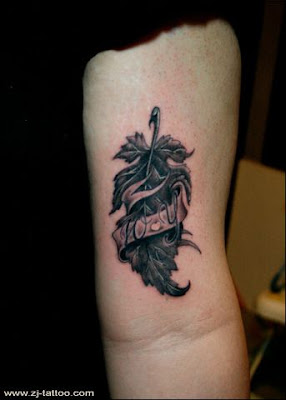 a leaf tattoo on the arm