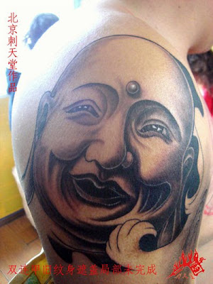 smiling Buddha tattoo on the arm smiling Buddha tattoo on the arm