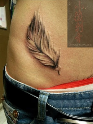a feather tattoo design on the hip