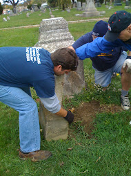 volunteers picking up headstones