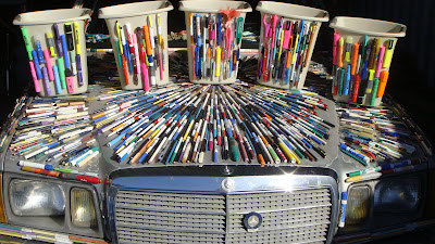 Five Pen Recycling Bins on the Hood of the Mercedes Pens