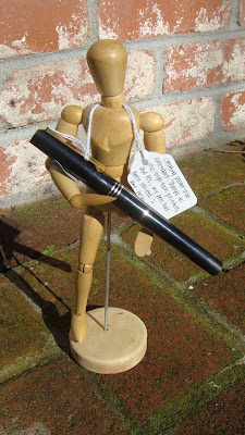 One Legged Wooden Model with Giant Calligraphy Pen