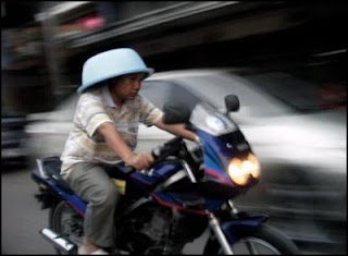 funny bowl wearing man on motorbike maybe as helmet picture