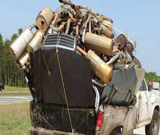 funny crazy photo of overloaded pick up truck full of mufflers and car parts