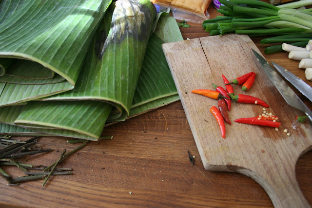 A banana leaf and chopping chillies