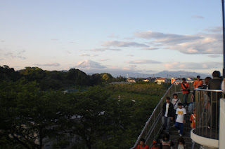 Fans file out as Mount Fuji looms in the background