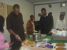 Staff serves up Kwanzaa meal enjoyed by families each year.