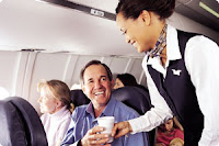 An ASA flight attendant serves passengers ASA flight attendant