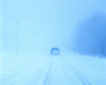 car driving in blizzard