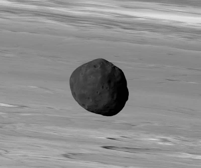 The dark surface of Phobos with Mars as the backdrop, as seen by the European Mars Express ESA.