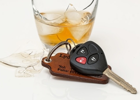 A glass of wine and car keys. A glass of wine and car keys.