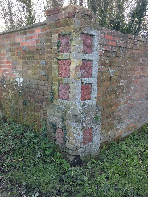 Ornate tiles on a wall near Burbage