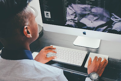 A photo of a college student using a computer, presumably learning how to raise your GPA