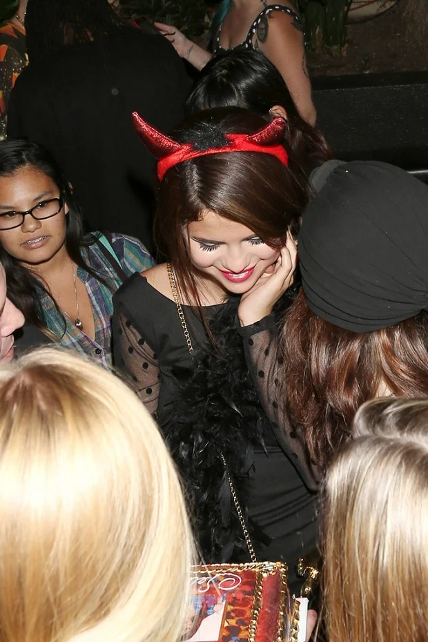 Selena Gomez celebrates 21st birthday in little black dress and red devil horns
