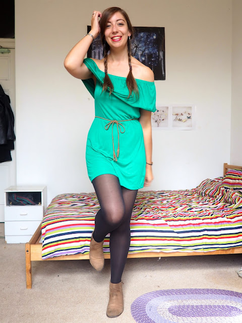Peter Pan inspired Disneybound outfit of green off-the-shoulder dress, black tights, brown belt & ankle boots