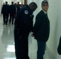 Photo of Josh Fox being handcuffed by a Capitol police officer