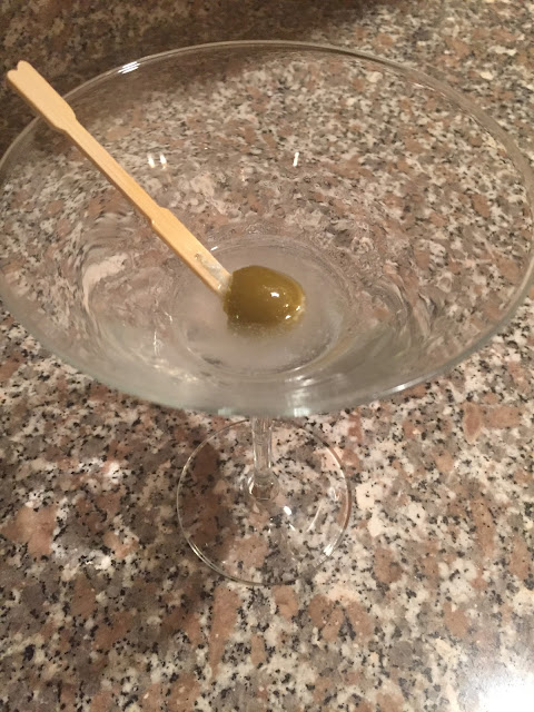 end of a dry martini with bleu cheese-stuffed olives