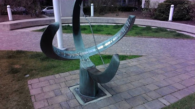 curved sundial at Elm and McCaul