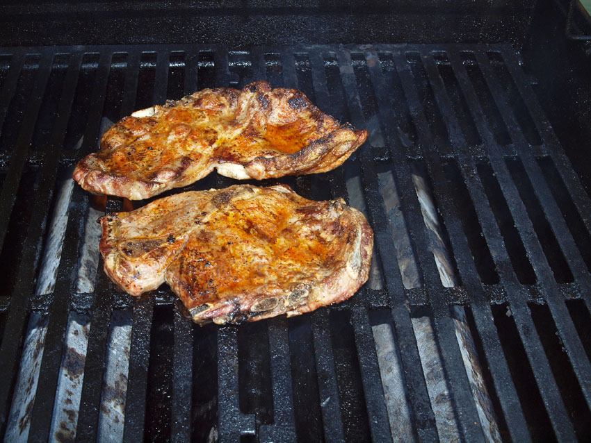 Pellet Smoker Cooking Grilled Pork Steaks, Fried Hash Browns and