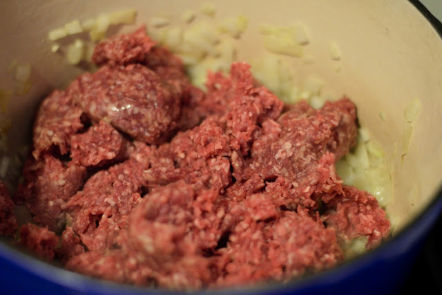 Ground meat in the pot. 