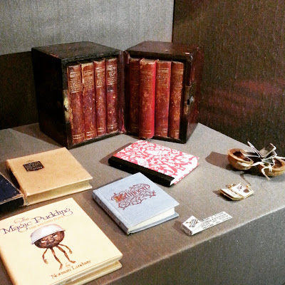 Selection of miniature books on display.