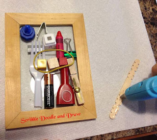 art activity for kids arranging found objects in a frame