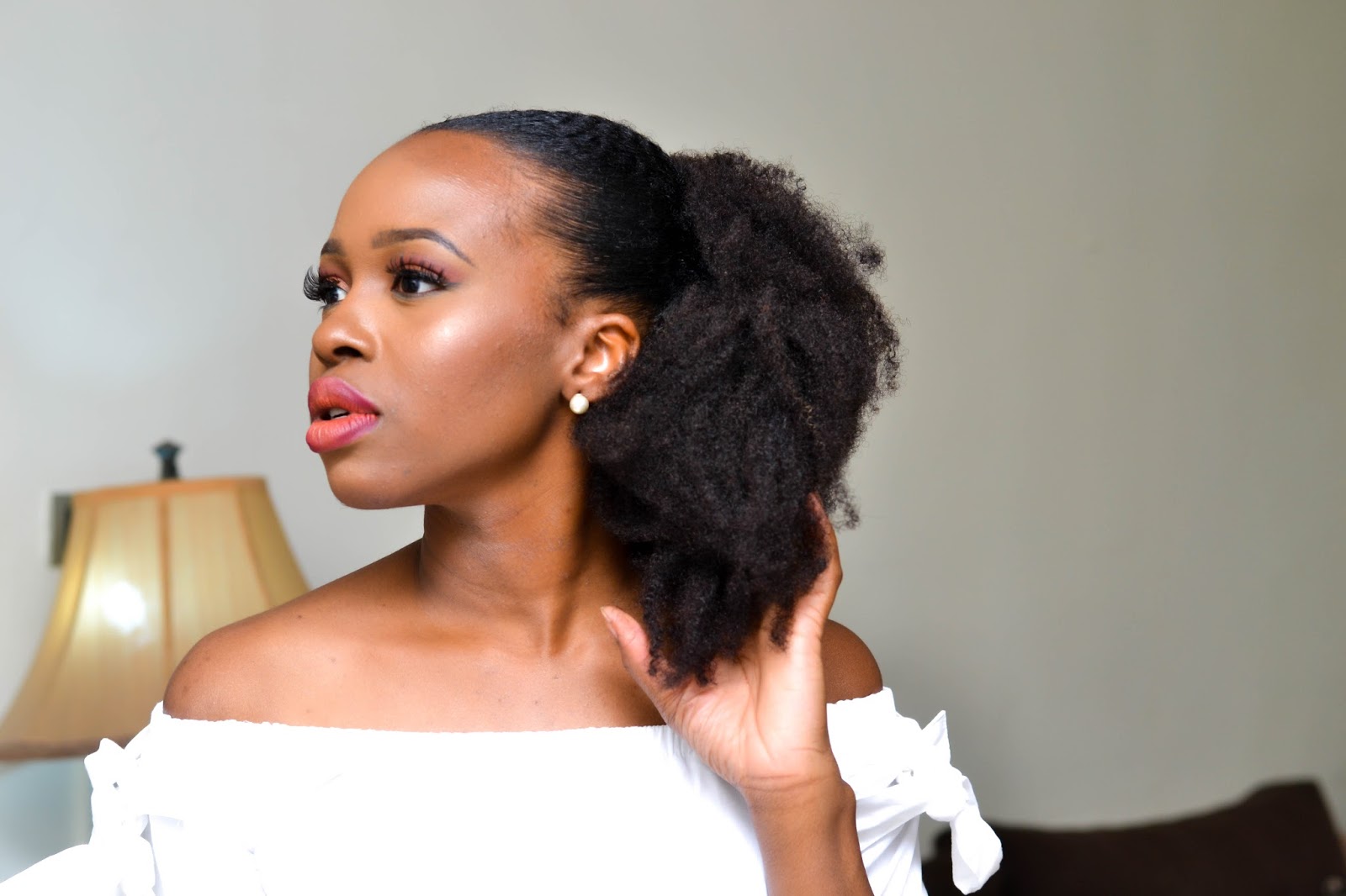 A Sleek Natural Low Puff Ponytail With Kinky Hair Extensions
