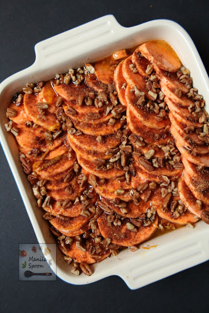 Flavored with honey and orange juice then studded with pecans this tasty Candied Sweet Potato Casserole is the perfect side dish for Thanksgiving. | manilaspoon.com