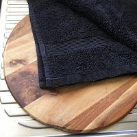 A heatproof board for filling jars, and dark towels for cleaning