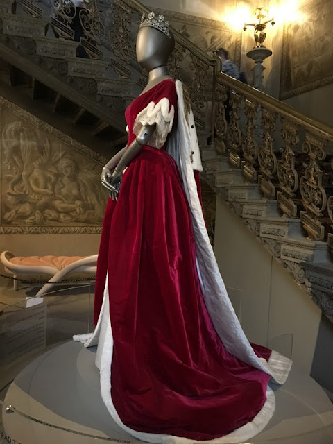 Wrapping Up England: dress that Deborah the Duchess of Devonshire wore to Queen Elizabeth's coronation in 1953 mannequin in a red velvet dress with white fur trimmed train