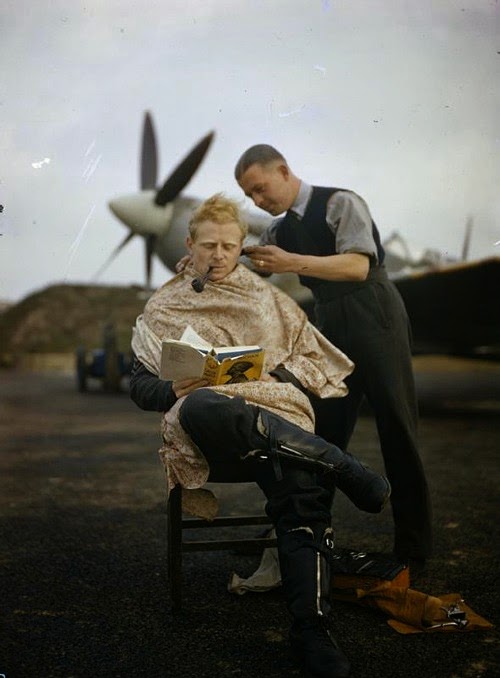 Royal Air Force, pilot getting haircut, between missions (1942).