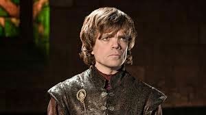 Tyrion Lannister, younger, blonde haired little person with a serious face