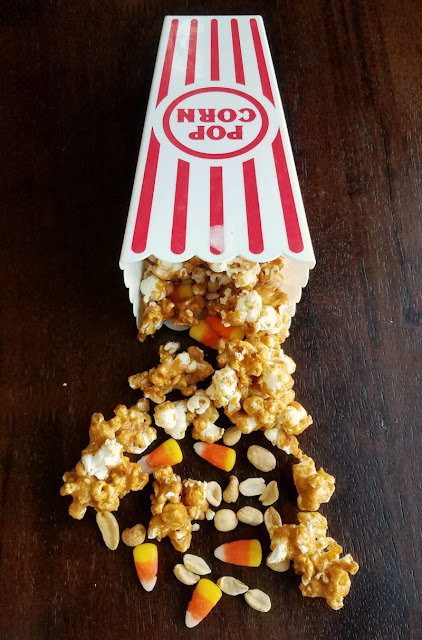 Sweet and salty crunch peanut popcorn with candy corn and peanuts for a fun version of hillbilly hash. A favorite fall treat just got upgraded! peanut butter popcorn, peanuts and candy corn spilling out of popcorn container