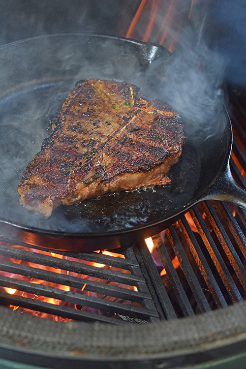 Pan seared t-bone steak on a kamado grill