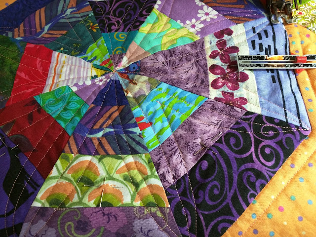 Planning the third round of point to point quilting on a spiderweb.