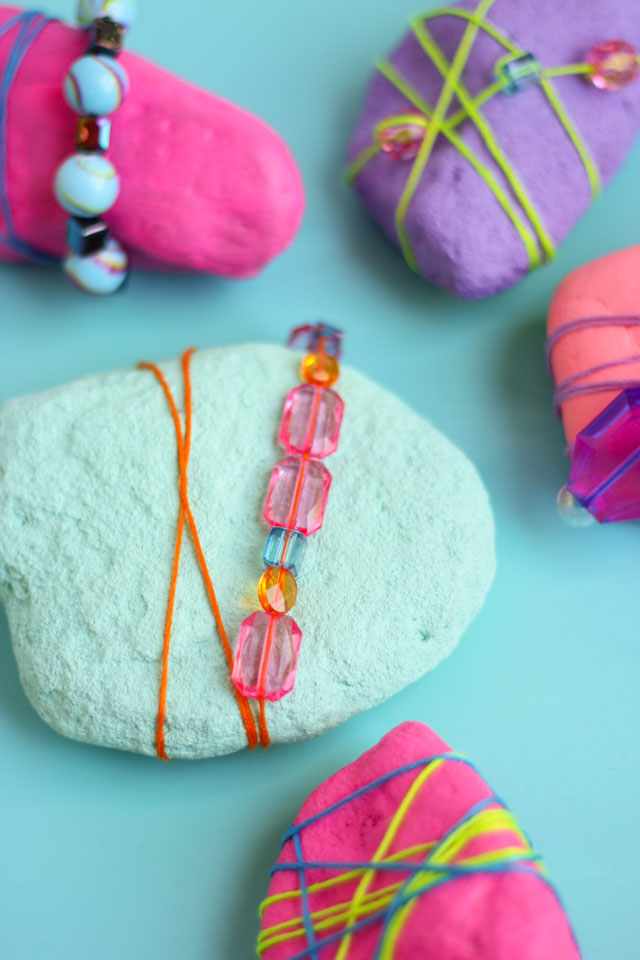 Rocks never looked so pretty! Decorate them with beads and jewels for pretty garden rocks or paperweights! #rockpainting #gardenrocks #kidscraft #naturecraft #kidmademodern Rocks never looked so pretty! Decorate them with beads and jewels for pretty garden rocks or paperweights! #rockpainting #gardenrocks #kidscraft #naturecraft #kidmademodern