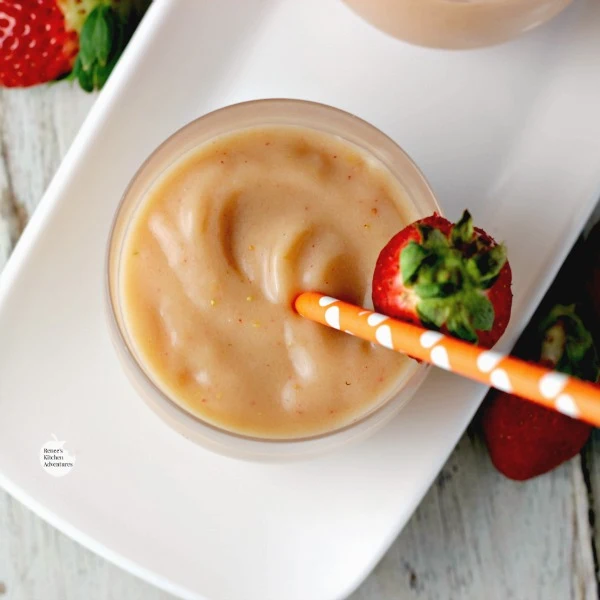 Overhead view of Easy Strawberry Mango Smoothies | by Renee's Kitchen Adventures on a white platter.