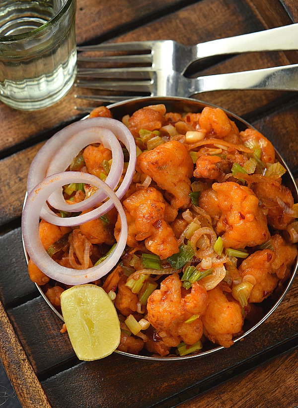 Restaurant style Gobi Manchurian served on a plate in a wooden tray