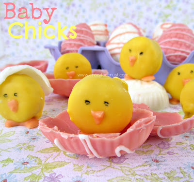 baby chick mini oreo dipped in yellow chocolate sitting on half a pink chocolate easter egg