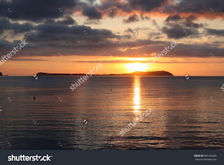 sunset in Ibiza,dawn in Ibiza,fishermen out at dawn in his fishing boat on a sunny day with some clouds on the horizon, golden yellow sun and golden sun wake in the sea, a calm Mediterranean Sea, sunset in Ibiza,dawn in Ibiza,fishermen out at dawn in his fishing boat on a sunny day with some clouds on the horizon, golden yellow sun and golden sun wake in the sea, a calm Mediterranean Sea,