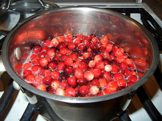 Cranberries boiling in sugar water to make cranberry sauce