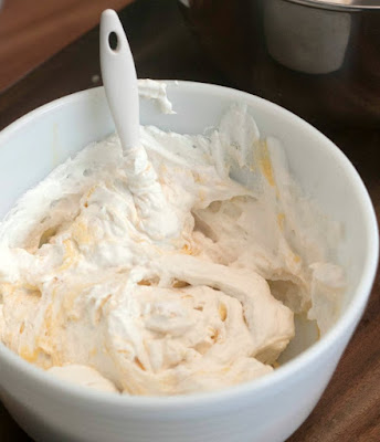 mixing bowl full of easy no bake banana cream pie filling ready to go into the graham cracker crust
